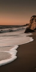 Wall Mural - Serene sunset beach with gentle waves and rocky cliffside