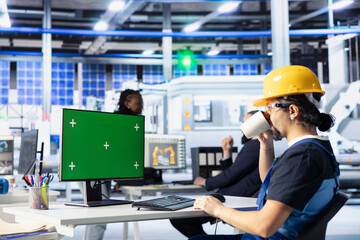 Poster - solar panels plant engineer drinking coffee doing quality control using green screen computer. photo