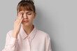 © Pixel-Shot - Tired young businesswoman on light background, closeup. Glaucoma awareness month