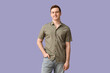 © Pixel-Shot - Handsome young man in stylish green collar shirt on lilac background