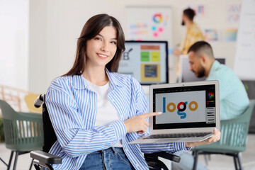 Poster - Female designer in wheelchair with laptop at office