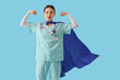 © Pixel-Shot - Female Asian doctor with superhero cape showing muscles on blue background. International Nurses Day