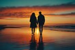 © otwdesign - Couple walking hand in hand along the beach at sunset