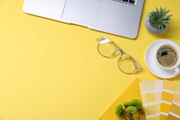 Aufkleber - Designer's workplace with laptop, stationery and cup of coffee on yellow background, flat lay. Space for text