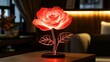 © nodabandel132 - Illuminated red rose table lamp on wooden surface.
