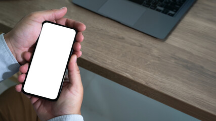 Poster - top view mockup image hand using a smartphone man holding cell phone with blank screen