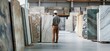 © Picstings - Male worker examining marble slabs in a warehouse.