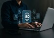 © homan - Hands on laptop with ISO icon, quality icons.