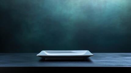 Aufkleber - Empty square white plate on dark table against a moody teal background.