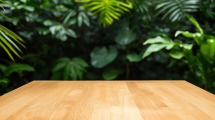 Poster - A wooden table in the foreground, set against a lush green backdrop of tropical foliage, creating a serene and natural atmosphere.