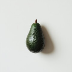 Aufkleber - Ripe avocado with smooth skin resting on a light surface in a kitchen setting during daytime