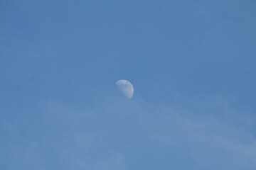 waxing moon in blue sky