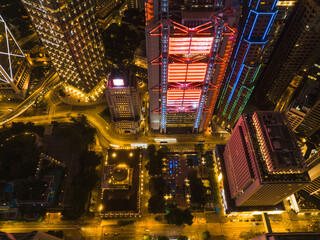 Poster - Aerial panorama of Hong Kong city at night showcasing illuminated skyscrapers and urban landscape. Street lights and building lights create a vibrant cityscape.