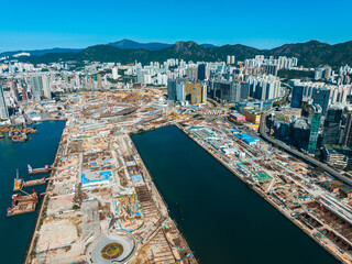 Poster - Aerial panorama of Hong Kong, China, showcasing urban development by the waterfront. Cityscape with buildings, mountains and harbour view in a broad scenic shot.