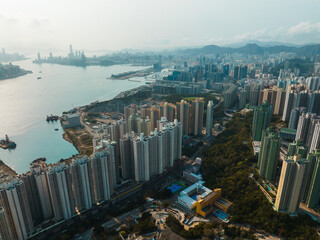 Poster - Aerial panorama of Hong Kong city showcasing dense buildings near the waterfront, capturing the vast urban landscape.