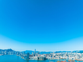 Aufkleber - Aerial panorama of Hong Kong city under a clear blue sky. Wide cityscape view showcasing the urban landscape and harbor from above.
