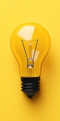 Poster - Yellow Light Bulb on Vibrant Yellow Background, Concept for Innovation, Creativity, and Ideas