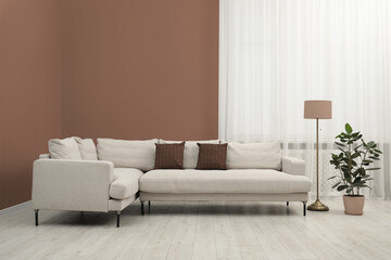 Poster - Stylish living room with elements in mocha mousse shade. Interior design with trendy color of 2025 year