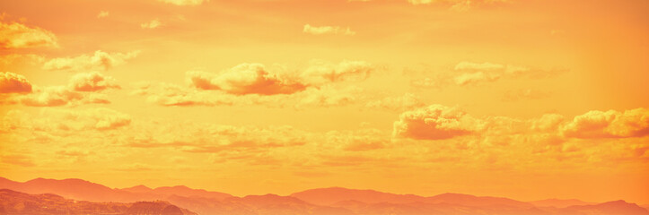 Wall Mural - cloudy sky over mountains at golden sunset. abstract nature background. basque country, spain. horiz