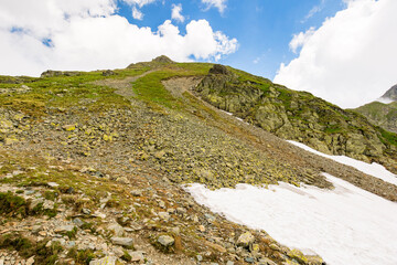 Wall Mural - landscape with mountain and blue sky with clouds. steep hill with stones and grass. beautiful nature