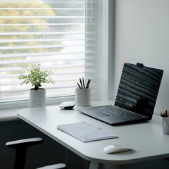 Poster - Modern desk featuring a sleek laptop and vibrant green plant adding life to the work environment