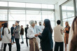 © Jacob Lund - Diverse professionals networking at a business event in a modern office building