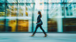 © Anna - Blurred background with walking business woman