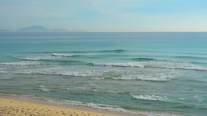 Wall Mural - Landscape of the morning beach with turquoise water and light suns at low tide