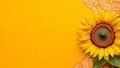 © A4719 - Single sunflower with green leaf on yellow background, adorned with yellow patterned lace. Bright, cheerful, summery mood.
