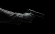 © Rawf8 - Gun on dark background, closeup, gloved hand holding a pistol. Crime, murder