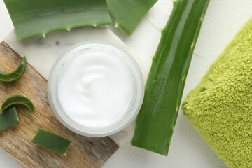 Wall Mural - cream and aloe leaves on white textured background, flat lay