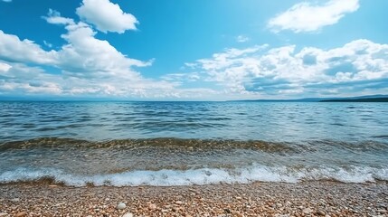 Poster - Stunning view of the beach with gentle waves lapping against the shore under a blue sky : Generative AI