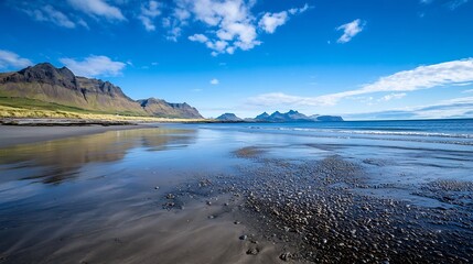 Poster - Serene coastal landscape with mountains and clear blue skies reflecting on sandy beach : Generative AI