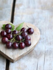 Aufkleber - Freshly picked red grapes arranged beautifully on a rustic wooden heart shaped board : Generative AI