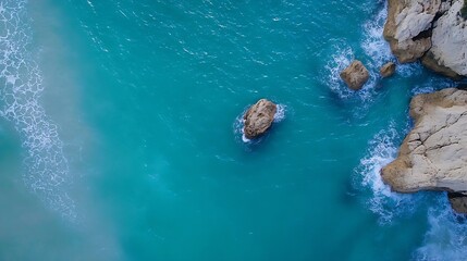 Aufkleber - Aerial view of crystal clear turquoise sea waves crashing against rocky coast under sunny skies : Generative AI
