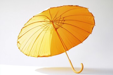 Aufkleber - A single yellow umbrella lying on a white surface