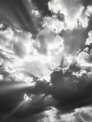 Aufkleber - Dramatic black and white clouds capturing sunlight beams breaking through the overcast sky : Generative AI