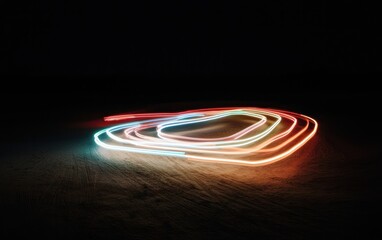 Fototapete - Abstract light painting artwork featuring vibrant red, blue, and orange light trails on a dark background. The light trails create swirling, concentric patterns on a textured surface