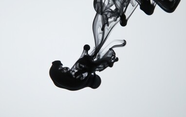 Poster - Abstract image of black ink swirling in water against a white background. The ink creates interesting shapes and textures as it diffuses