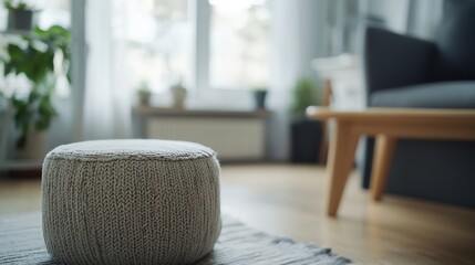 Poster - Cozy Living Room with a Soft Knit Pouf in Focus Surrounded by Natural Light and Greenery : Generative AI