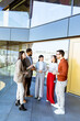 © BGStock72 - Colleagues engaging in lively discussion during a networking event in a modern office space