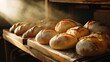 © นพรัตน์ เขมนพันธ์ - Freshly baked bread steaming on wooden rack.