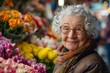 © S photographer - A joyful elderly woman smiles among vibrant flowers at a market, showcasing the beauty of nature and human connection.