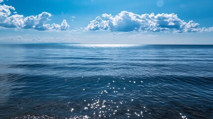 Leinwandbilder - Glistening blue ocean under a bright sky with fluffy clouds reflecting on the water surface : Generative AI