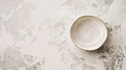 Wall Mural - serene bowl: an empty, handcrafted bowl rests delicately on a textured surface, exuding simplicity a