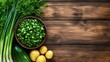 © lililia - Chopped green onions are neatly arranged in a bowl beside rustic potatoes and chives on a wooden table, showcasing vibrant colors