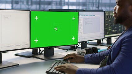 Poster - engineer using green screen computer in server room, developing disaster recovery plans ensuring min