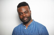 © Sotnikow - Portrait of a confident Black man with well-groomed beard wearing a denim shirt against a white background