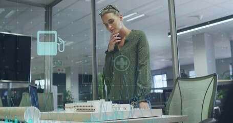Poster - Analyzing architectural model with digital overlay, businesswoman in modern office