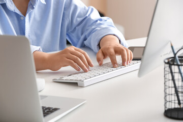 Wall Mural - female programmer typing on computer keyboard in office, closeup
